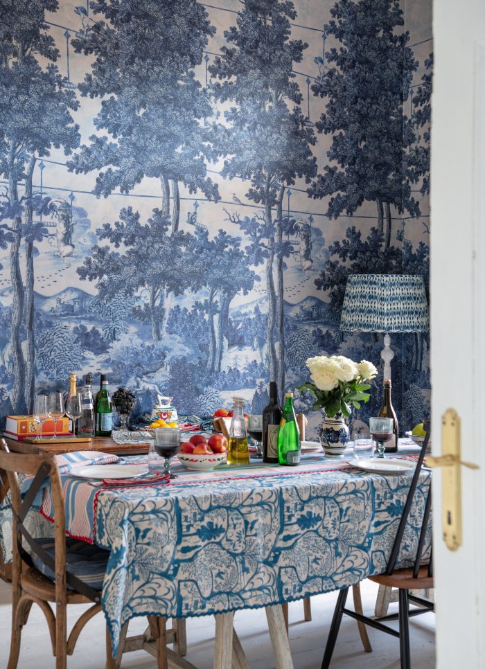 TOILE DU CARPATHIANS Indigo wallpaper, styled with a striped table setting